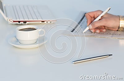 Angle View of Work Place with Laptop Color Pencils and Business Newspaper Stock Photo