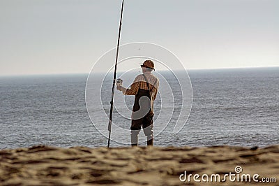 Angler fishing on the beach shore Editorial Stock Photo