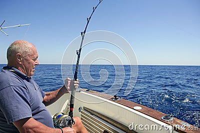 Angler senior big game sport fishing boat Stock Photo