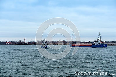 Angling vessel. A fishing vessel enters the harbor. The blue ship is going into port Editorial Stock Photo