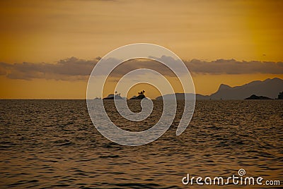 Angra dos Reis, Brazil, Ilha Grande: Beautiful scenery with ships overlooking the sea and mountains at sunset Stock Photo