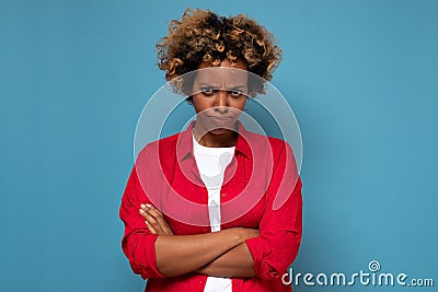 Angry annoyed african woman keeping arms crossed and staring at camera with sceptical and distrustful look Stock Photo