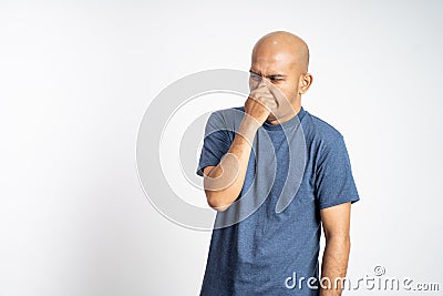 angry asian bald man covering nose with hands Stock Photo