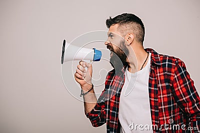 Angry bearded man in checkered shirt screaming into megaphone, isolated Stock Photo