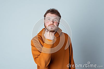 Angry bearded young man raising fist frustrated and furious. Rage and aggressive concept Stock Photo