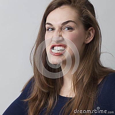 Angry beautiful 20s girl grinding her teeth threatening Stock Photo