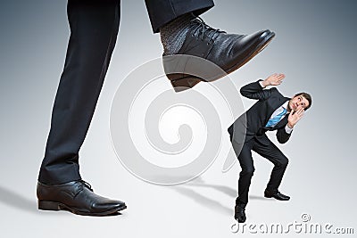 Angry big businessman is abusing small employee Stock Photo