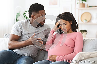 Angry black man fighting with his upset pregnant wife Stock Photo
