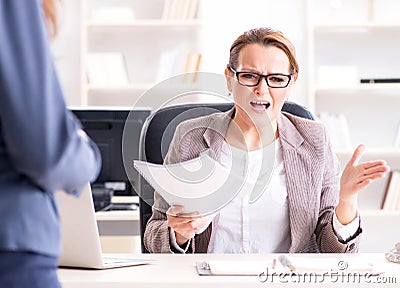 Angry boss dismissing employee for bad underperformance Stock Photo