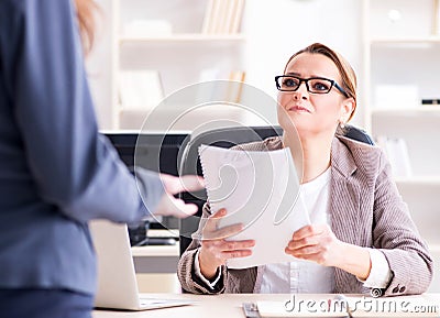 Angry boss dismissing employee for bad underperformance Stock Photo