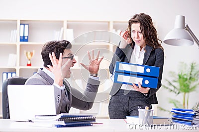 The angry boss unhappy with female employee performance Stock Photo