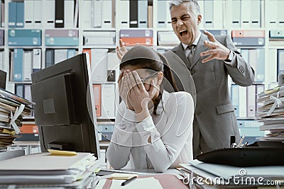 Angry boss yelling at his young employee Stock Photo