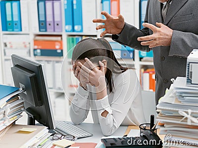 Angry boss yelling at his young employee Stock Photo