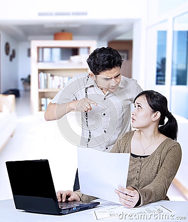 Angry boyfriend pointing at home Stock Photo