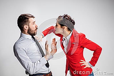 The angry business man and woman conflicting on a gray background Stock Photo