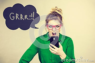 Angry business woman looking at phone, thinking bubble Stock Photo