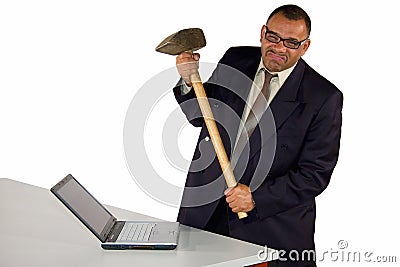 Angry businessman hitting laptop with sledgehammer Stock Photo