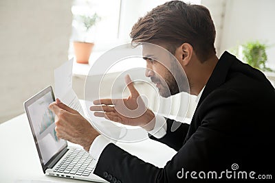 Angry businessman feeling indignant disagree with information in Stock Photo