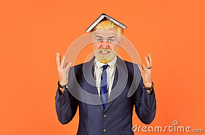 Angry businessman notebook on head. mature man dyed beard and hair. tired reading book. too much work. daily schedule Stock Photo