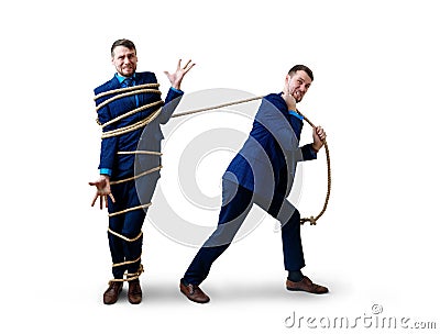 Angry businessman pulls tied himself with a rope. Stock Photo