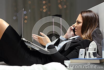 Angry businesswoman complaining on phone in an hotel Stock Photo