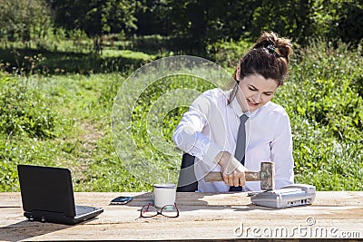 Angry businesswoman destroys the phone with a hammer Stock Photo