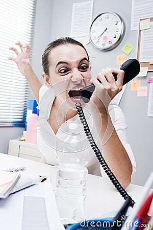 Angry businesswoman on the phone Stock Photo