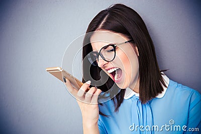 Angry businesswoman shouting on smartphone Stock Photo