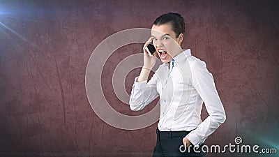 Angry businesswoman, standing by side, talking by mobile phone, emotional screaming, yelling. Isolated studio background Stock Photo