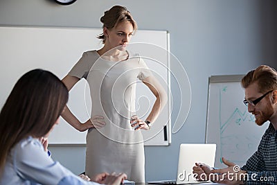 Angry businesswoman waiting for worker explanation of failure Stock Photo