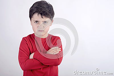 Angry child with folded arms Stock Photo