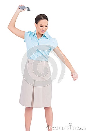 Angry classy businesswoman throwing her calculator Stock Photo