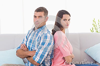 Angry couple sitting arms crossed on sofa Stock Photo