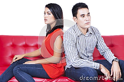 Angry couple sitting back to back Stock Photo