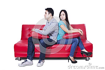 Angry couple sitting back to back Stock Photo