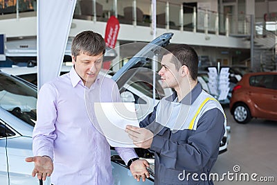 An angry customer talking to a mechanic in auto repair service Stock Photo