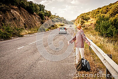 Angry and disappointed woman hitchhiker Stock Photo