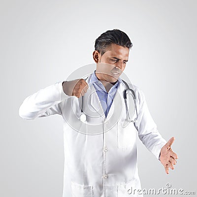 Angry doctor hiting hand with tension Stock Photo