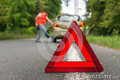 Angry driver kicking the tires on broken car Stock Photo