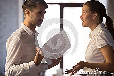 Angry employees arguing, discussing business failure, bad work results Stock Photo