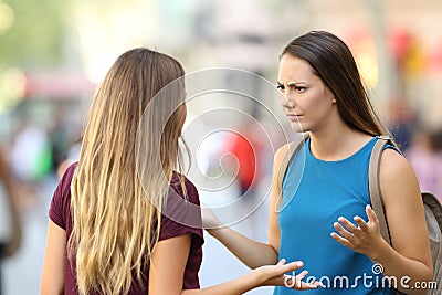 Angry friends having a serious conversation outdoors Stock Photo