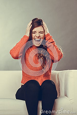 Angry furious outraged young woman girl. Headache. Stock Photo