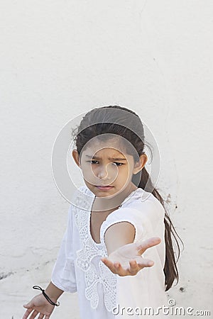 Angry kid girl saying - give back. Give it back, it`s mine. Loneliness concept. Cute girl saying - don`t leave me, take me with Stock Photo