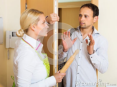 Angry girl threatens with rolling-pin Stock Photo