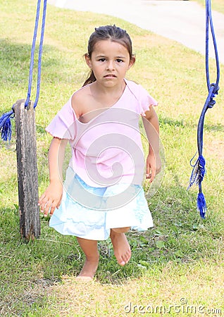 Angry girl walking from broken swing Stock Photo