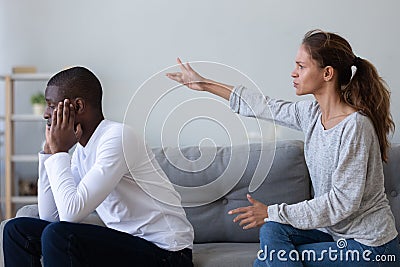 Angry girlfriend blaming African American boyfriend, relationship problem Stock Photo