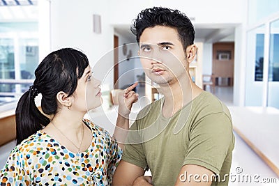 Angry girlfriend pointing at boyfriend at home Stock Photo