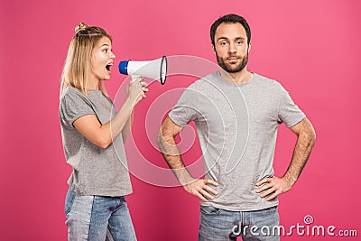 angry girlfriend shouting with megaphone at boyfriend, isolated Stock Photo