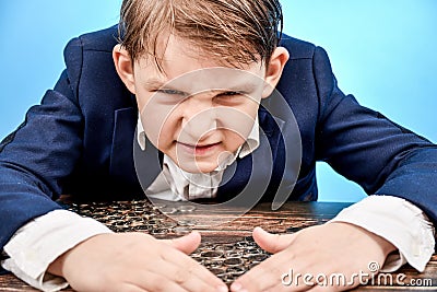 The angry and greedy boy covered the coins with his hands and does not give them to anyone Stock Photo