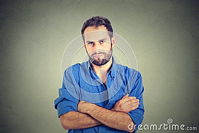 Angry grumpy young man looking very displeased Stock Photo